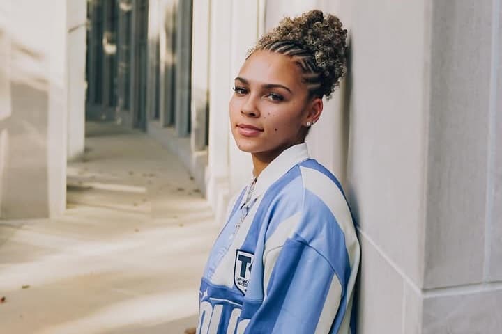Iowa State point guard Jada Williams shooting a jump shot in a crowded Hilton Coliseum during her record-breaking 44-point game against Cincinnati.